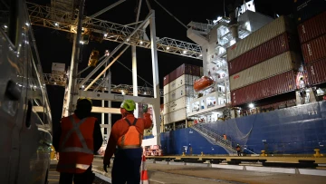Container ship night works two workers 