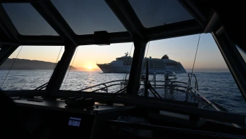 A cruise ship at sunrise through the windshield of Pilot Boat Te HAA